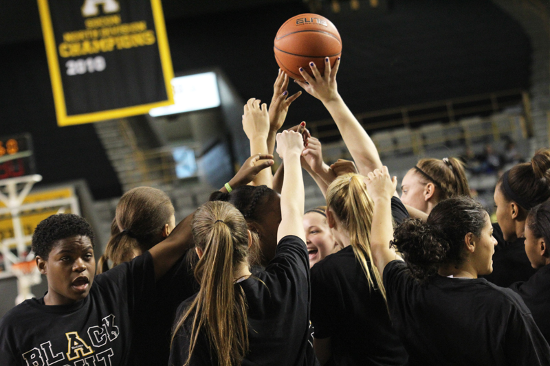 Members of the women’s basketball team in their pregame huddle before Saturdays Senior Day Black Out against Chattanooga. The Mountaineers lost the game 69-45. Paul Heckert | The Appalachian